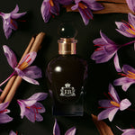 A 100 ml Oud Saffron Flower bottle lying next to some saffron flowers.